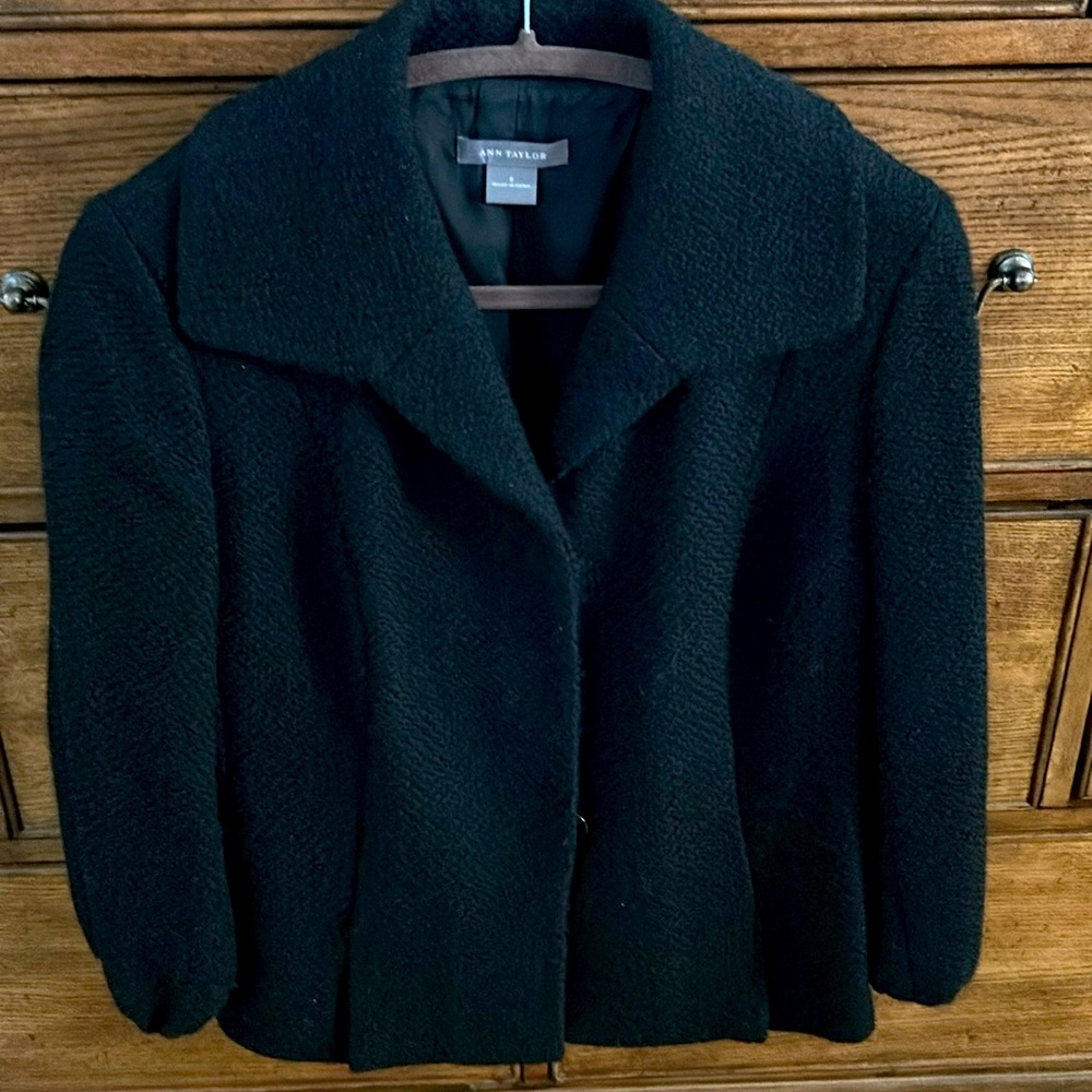 Wool black jacket. Form fitting around waist area.Hardly worn.3/4 length sleeves